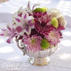 Purple, white, and green DIY arrangement in a silver creamer | flourishandknot.com