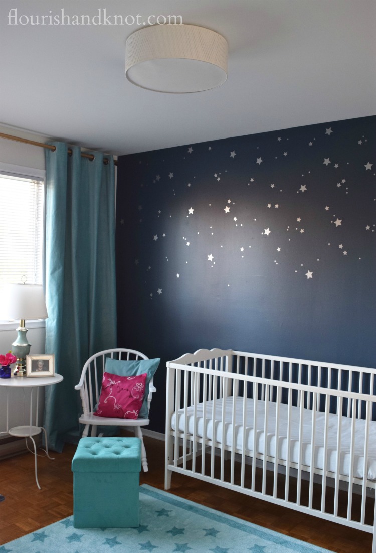 Navy, turquoise, pink, and white Harry Potter nursery with starry accent wall | flourishandknot.com