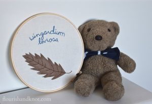 Teddy bear with lighting bolt bow tie and Wingardium Leviosa embroidery hoop