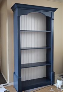 Navy blue and white painted bookcase | $100 Craft & Sewing Room Makeover | $100 Room Challenge | Navy, Goldenrod, and Fuschia palette | Week 3