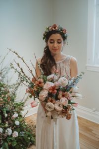Asymmetrical spring bouquet with pussy willows, delphinium, ranunculus, lisianthus, and tulips | Flourish & Knot | Burgundy, blue, and blush bouquet