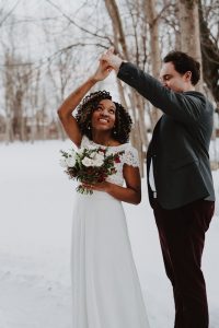 Winter wedding couple | Burgundy, red, and white winter wedding | Bridal bouquet of tulips, anemones, hellebore | Florals by Flourish & Knot | Photo by Photographie M'Vivre | Maison Trestler | Gown by Robelie | Makeup by Chrom Artistry