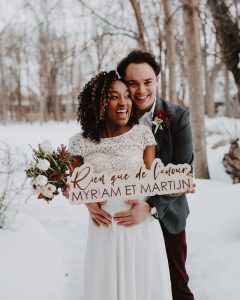 Winter wedding couple | Burgundy, red, and white winter wedding | Bridal bouquet of tulips, anemones, hellebore | Florals by Flourish & Knot | Photo by Photographie M'Vivre | Maison Trestler | Gown by Robelie | Makeup by Chrom Artistry | Signage by D Style Cut