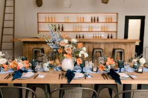 Wedding table design with blue and terracotta palette | High-end bud vase centrepieces in custom ceramic vessels by Flourish & Knot | Verger du Flanc Nord