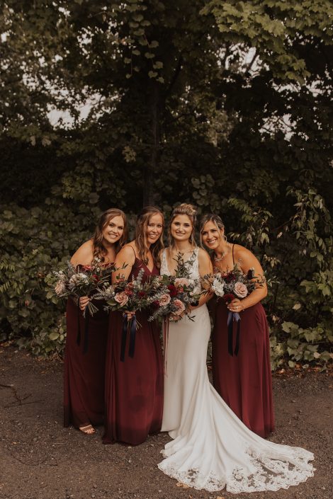 Bride with bridesmaids in burgundy with fall bouquets