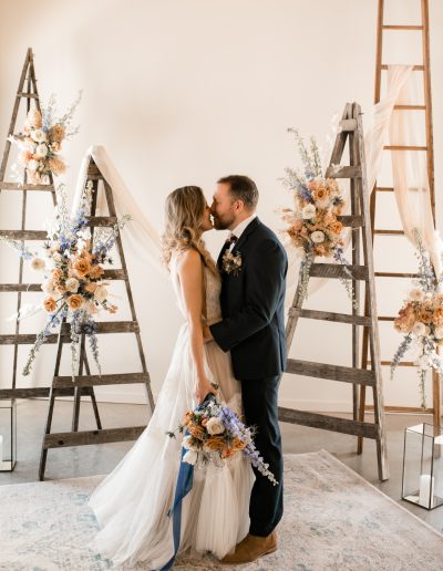 Bride and groom in front of orchard ladder wedding ceremony florals at Verger du Flanc Nord | Kerstin Hahn Photography | Flourish & Knot