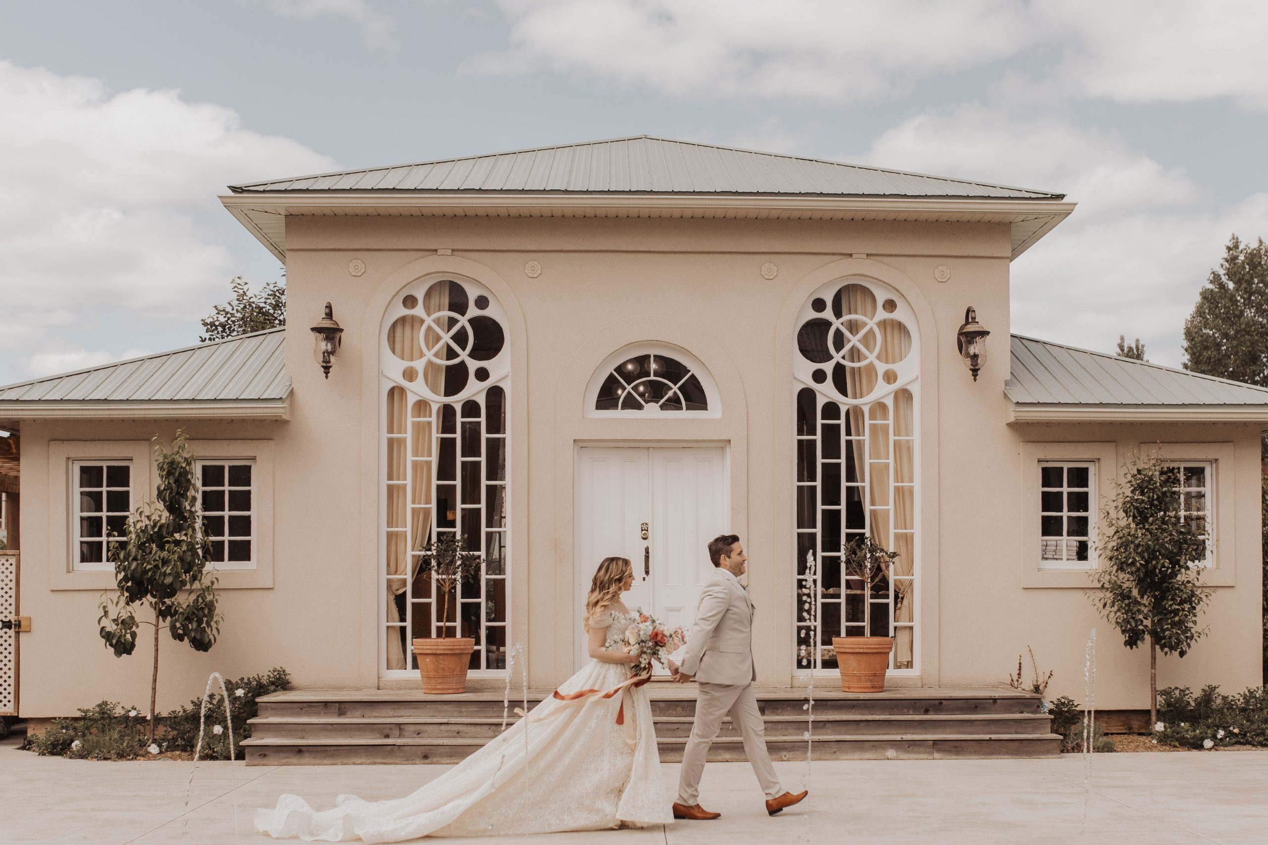 Bride and groom walking in front of French-style pavilion at Manoir Chamberland | Kerstin Hahn Photography | Flourish & Knot