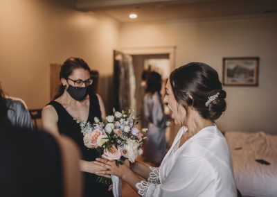Bride's happy reaction to seeing her Flourish & Knot bouquet