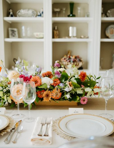 Colourful lush summer wedding centrepiece with dahlias and zinnias | L'Orangerie Photographie | Flourish & Knot