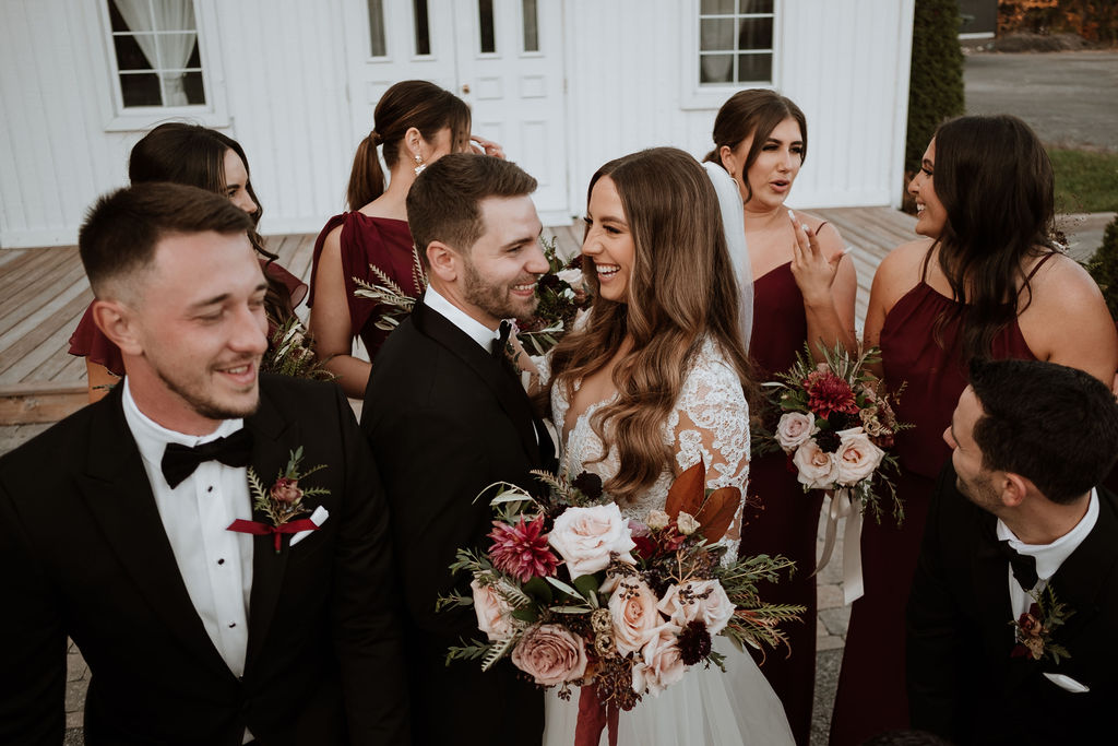 Wedding party having fun with fall bridal bouquet
