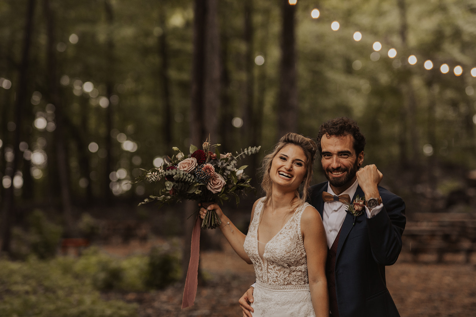 Happy bride and groom in forest with burgundy and mauve wedding bouquet | Kerstin Hahn Photography | La Bullerie