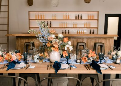 Terracotta blue orange cream tablescape with lush florals in boho wedding style at Verger du Flanc Nord | Kerstin Hahn Photography | Flourish & Knot
