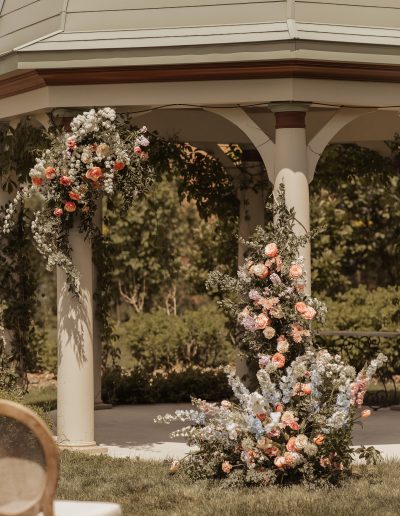 Lush spring garden-themed wedding ceremony flowers on Victorian gazebo at Manoir Chamberland | Kerstin Hahn Photography | Flourish & Knot