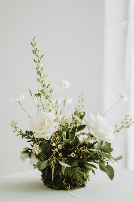 White and green wildflower-style centrepiece with moss | Flourish & Knot