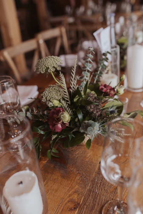 Wildflower-style organic wedding centrepiece in burgundy and navy | Flourish & Knot | Kerstin Hahn Photography | La Bullerie wedding