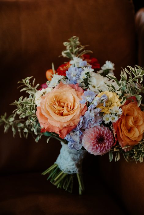 Colourful classic round bridal bouquet in orange, lavender, pink, and yellow tied with heirloom lace | L'Orangerie Photographie | Flourish & Knot