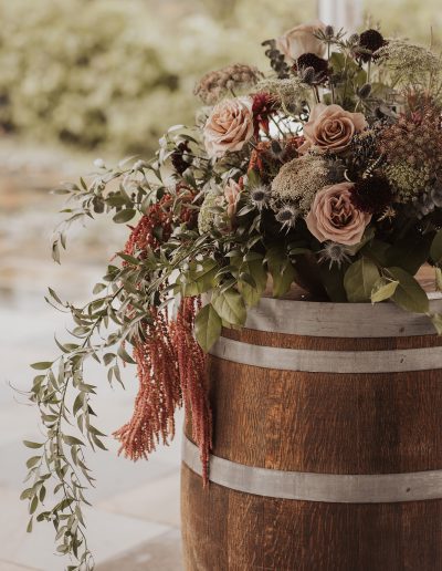 Lush wine barrel wedding ceremony flower arrangement in burgundy and mauve | Kerstin Hahn Photography | La Bullerie wedding | Flourish & Knot