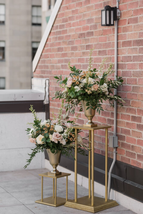 Large wedding ceremony floral arrangements in white and blush colours in gold vases on rooftop terrace | Flourish & Knot | Montreal wedding florist | Hotel Place D'Armes wedding | Montreal Old Port Wedding