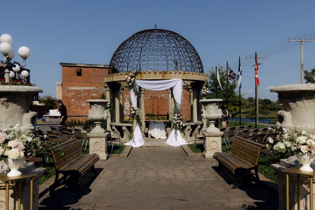 L'espace Canal wedding with flowers and drapery on their gazebo ceremony location.