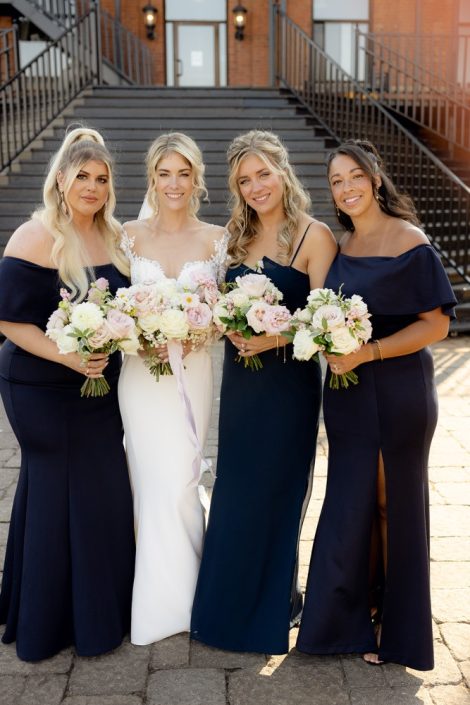 Bride and bridesmaids with white and pink bouquets
